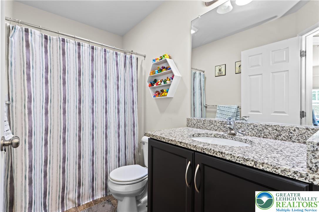 2260 Rising Hill Road Whitehall, PA 18052 - Photo 26 of 30 a bathroom with a granite countertop sink and a mirror