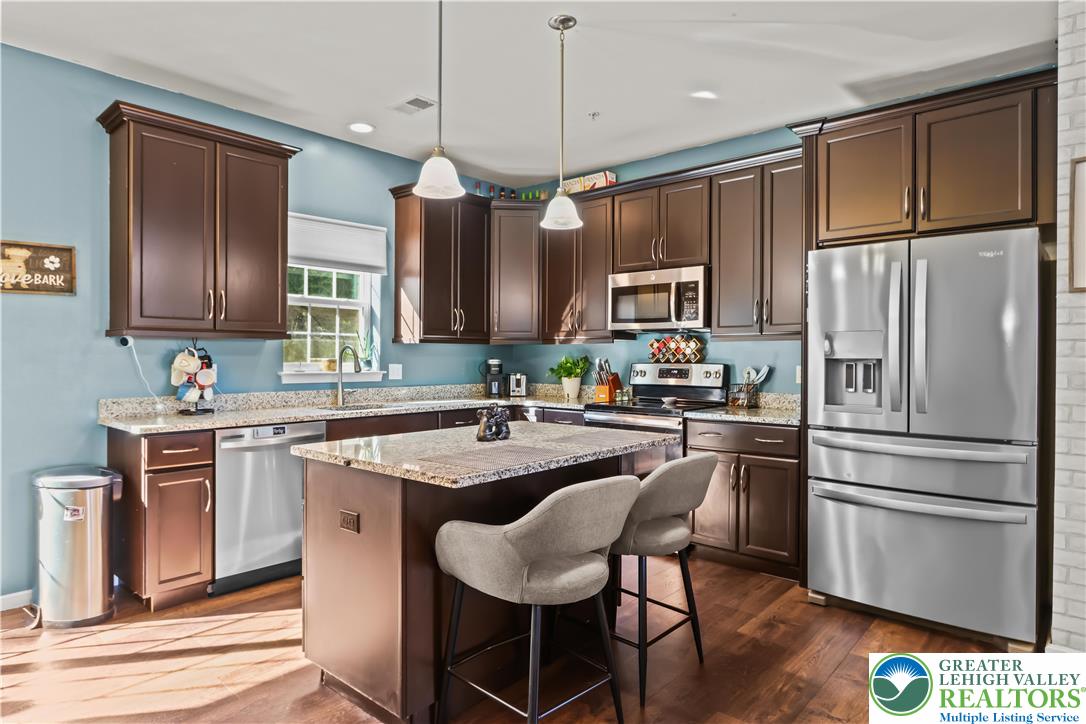 2260 Rising Hill Road Whitehall, PA 18052 - Photo 10 of 30 a kitchen with granite countertop a center island stainless steel appliances cabinets and a counter space