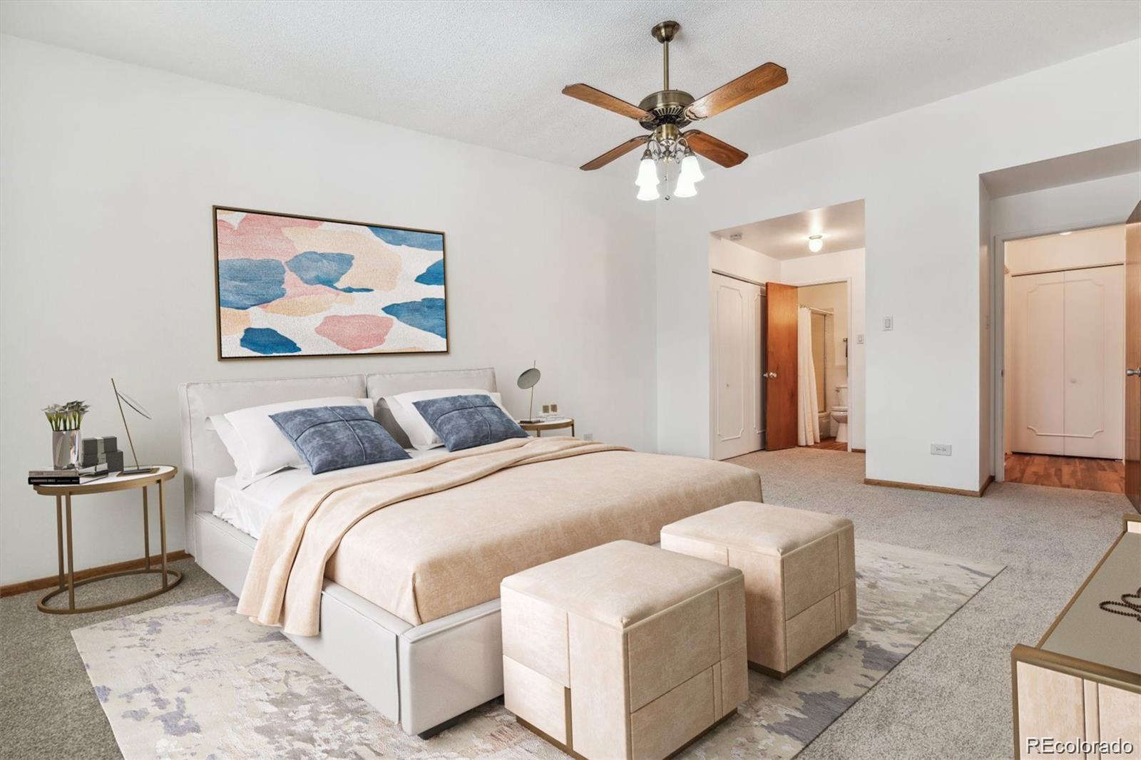 610 South Alton Way, Unit 8D Denver, CO 80247 - Photo 13 of 50 a spacious bedroom with a bed and a chandelier