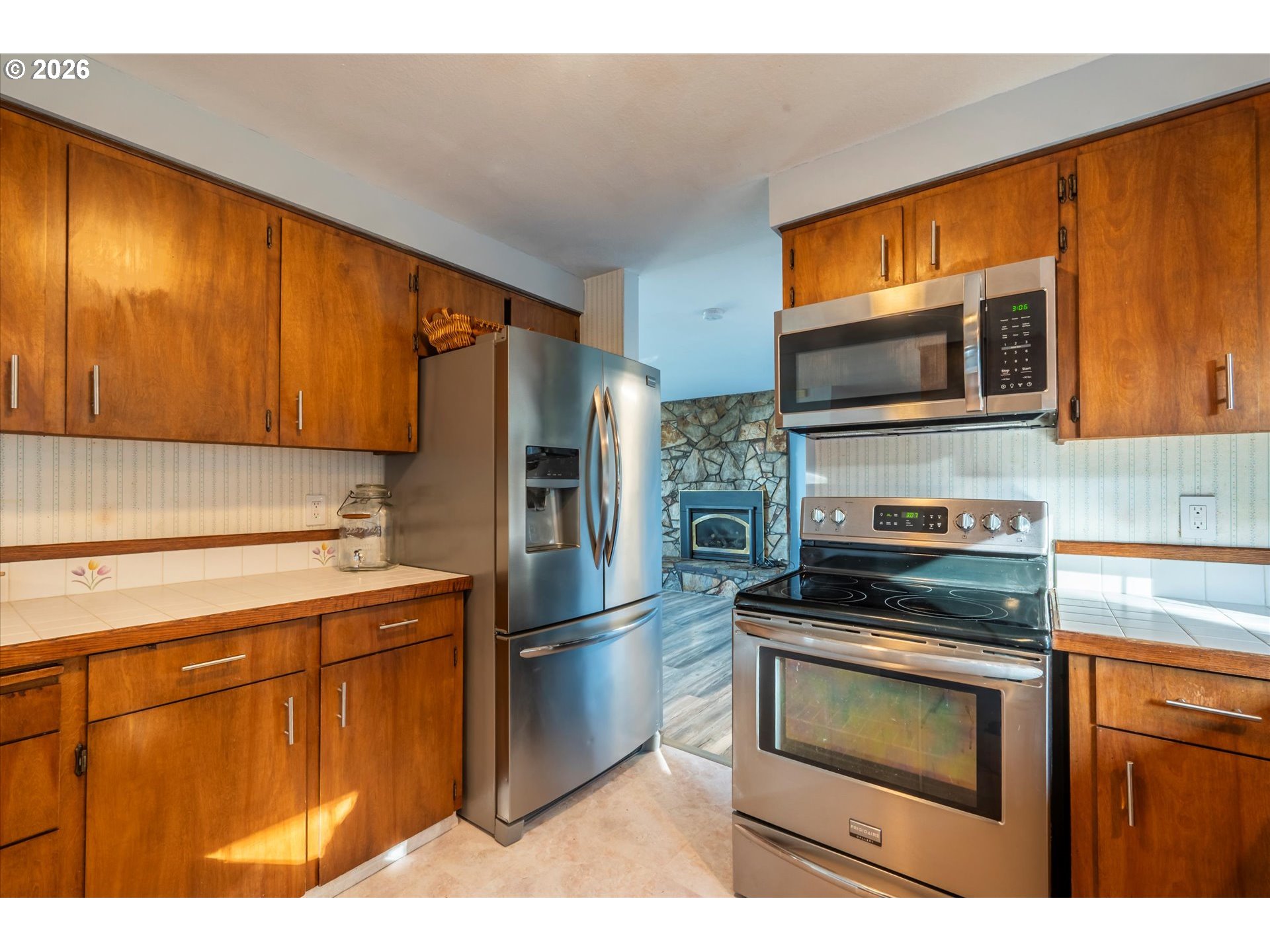 1376 D Street Coos Bay, OR 97420 - Photo 15 of 44 a kitchen with stainless steel appliances a stove microwave and refrigerator
