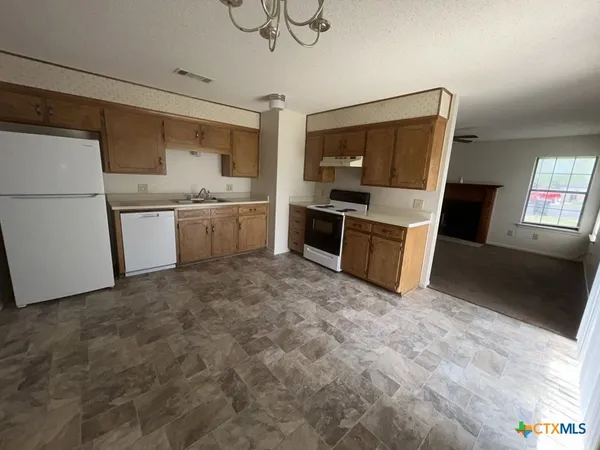 a kitchen with a sink cabinets and stainless steel appliances