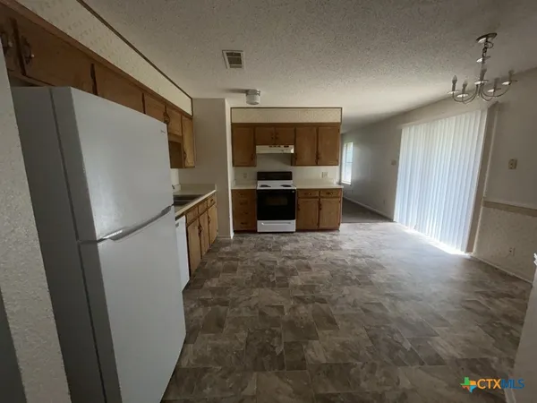 a kitchen with refrigerator and yard