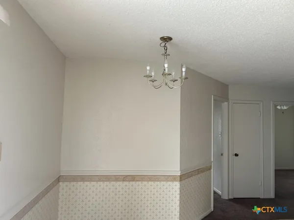 a view of a chandelier fan in a room
