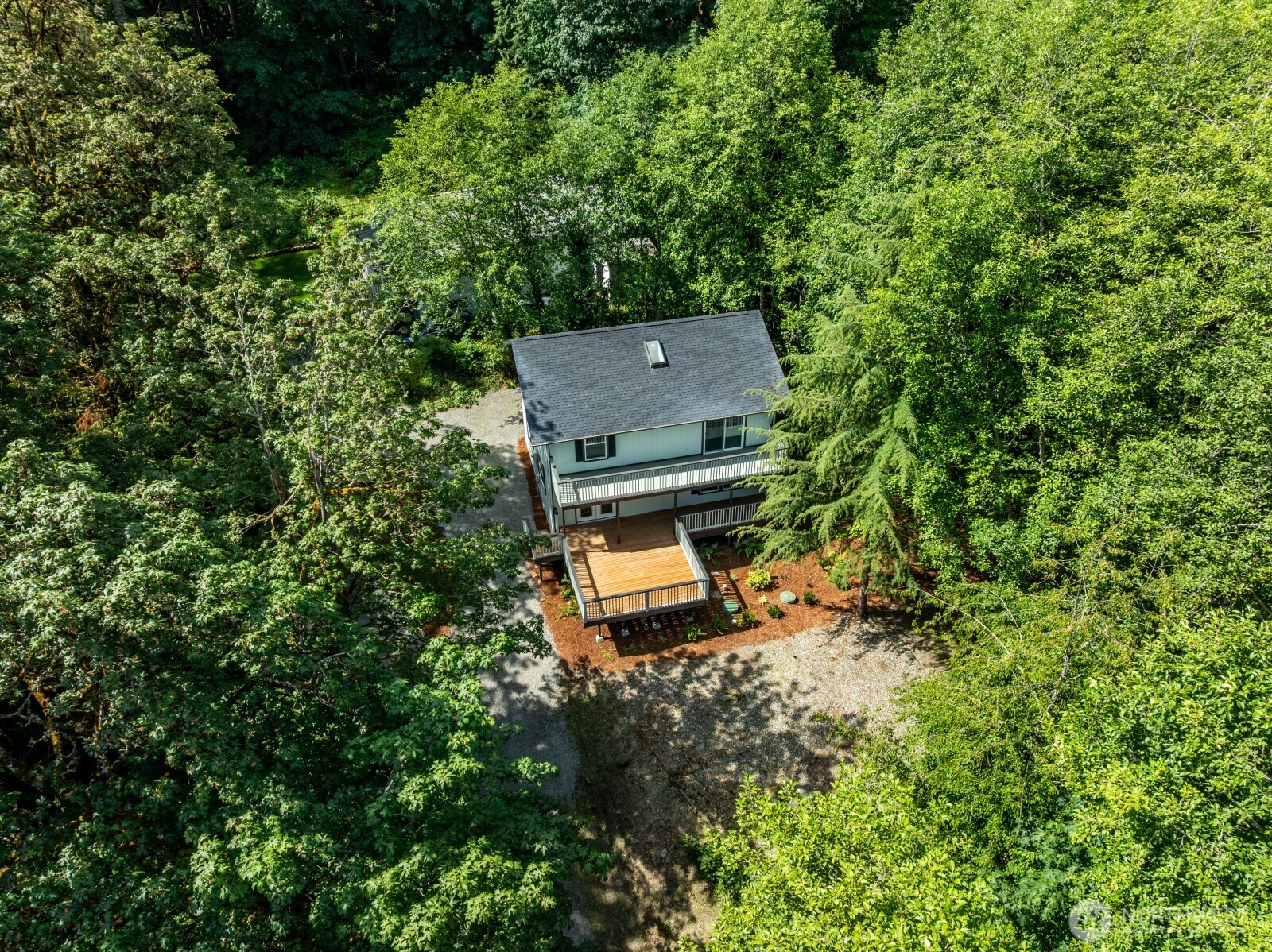 7605 Northeast Hidden Cove Road Bainbridge Island, WA 98110 - Photo 22 of 36 an aerial view of a house with a yard