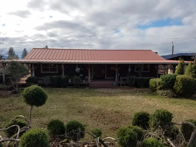 a backyard of a house with lots of green space and garden