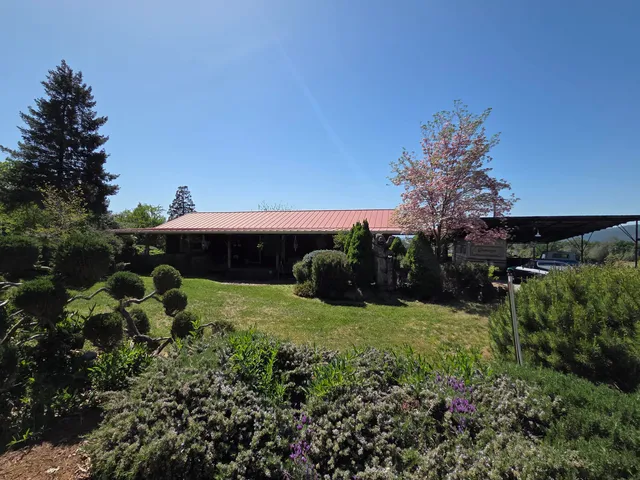 a front view of a house with a garden