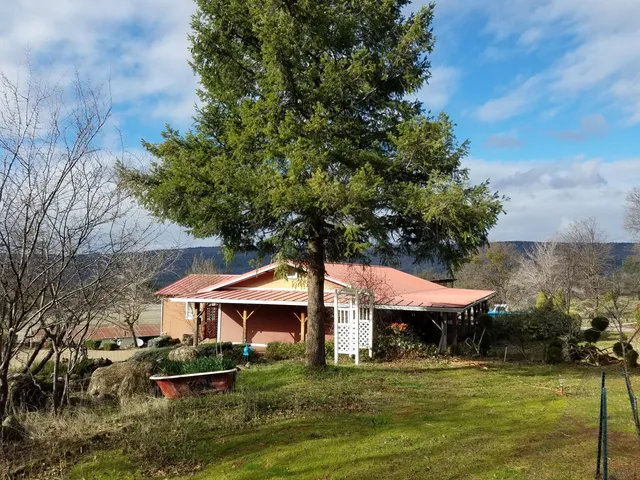 a view of a patio with table and chairs potted plants with wooden floor