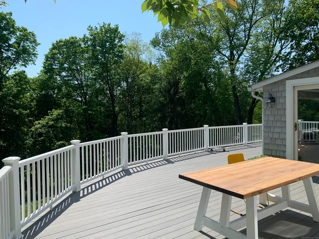 a kitchen with a table chairs sink and cabinets