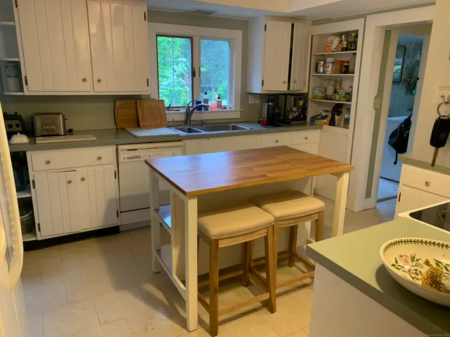 a living room with a large bed and a large window