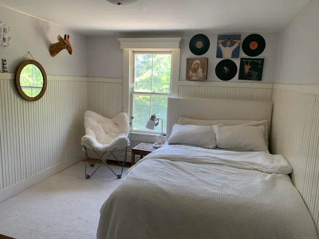 a bedroom with a bed and window