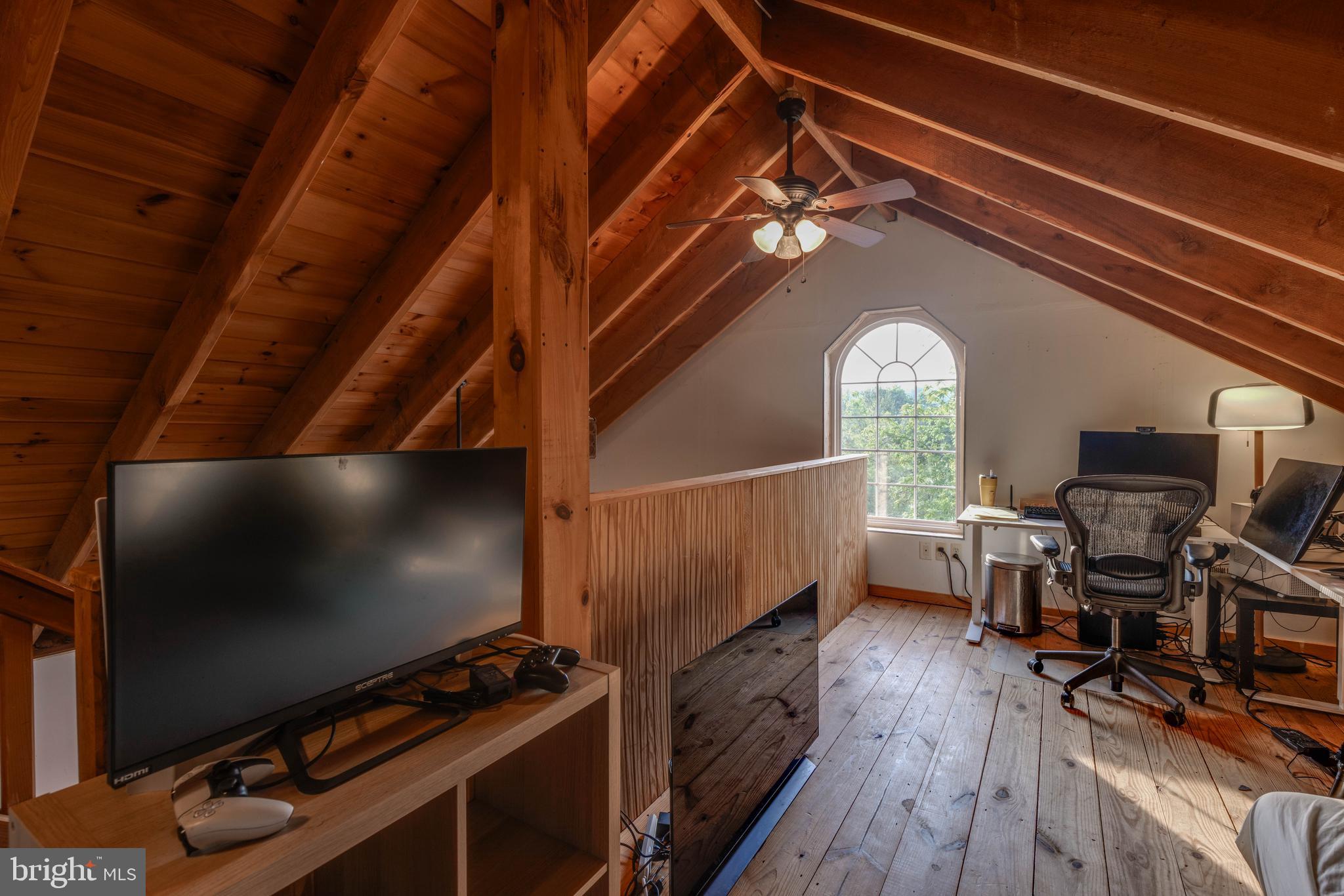 1801 Stringtown Road Sparks Glencoe, MD 21152 - Photo 19 of 26 a view of workspace with wooden floor and flat screen tv
