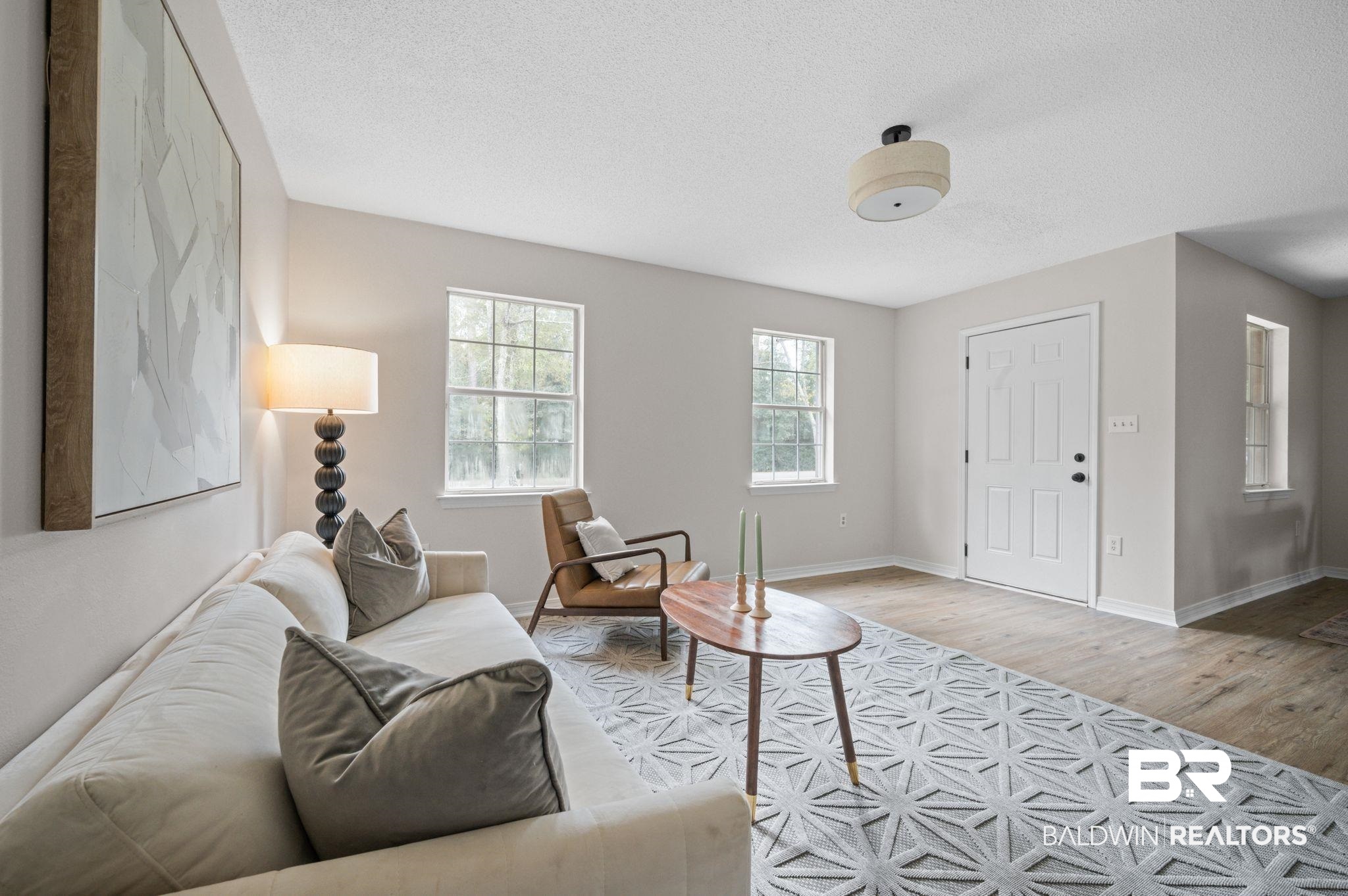811 East Verbena Avenue Foley, AL 36535 - Photo 10 of 16 Living room featuring a textured ceiling and light wood-type flooring