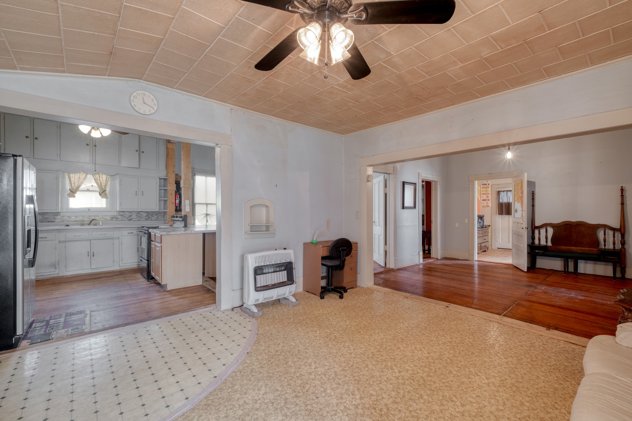 300 South Rio Grande Street Granger, TX 76530 - Photo 9 of 25 Living area featuring heating unit, a ceiling fan, light floors, and lofted ceiling