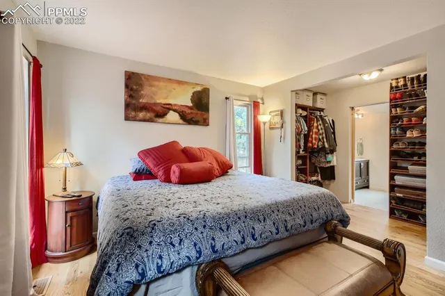 a bedroom with a bed and walk in closet