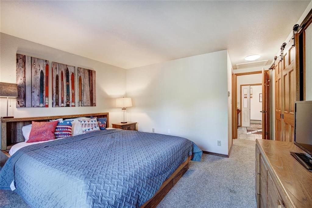 357 County Road 628 Breckenridge, CO 80424 - Photo 14 of 28 a bedroom with a large bed and a flat tv screen on dresser