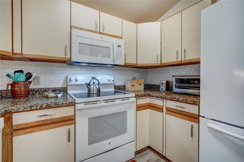 357 County Road 628 Breckenridge, CO 80424 - Photo 8 of 28 a kitchen with granite countertop white cabinets and white appliances
