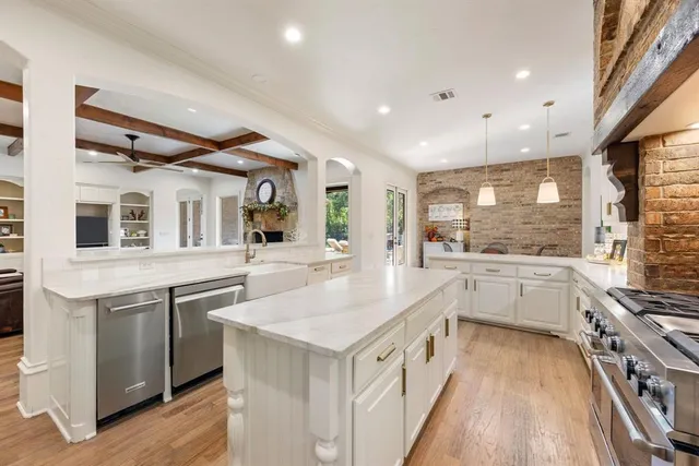 a kitchen with granite countertop a sink and a stove top oven
