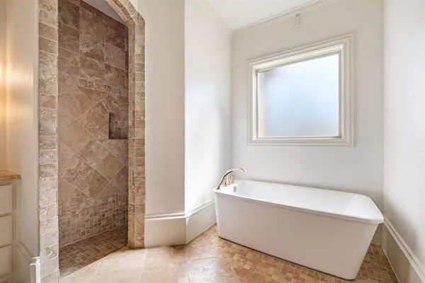 a bathroom with a bathtub and shower