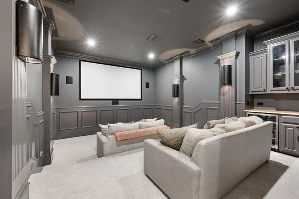 a living room with furniture kitchen view and a chandelier