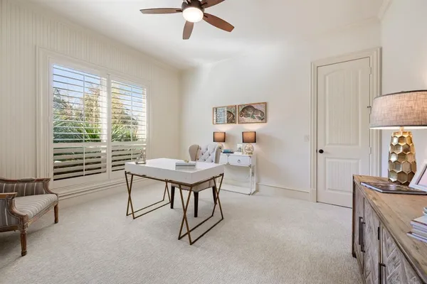 a bedroom with a bed wooden floor and a ceiling fan