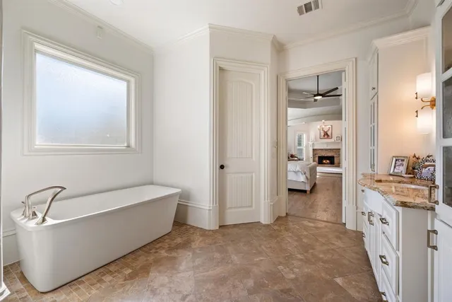 a spacious bathroom with a tub sink and shower