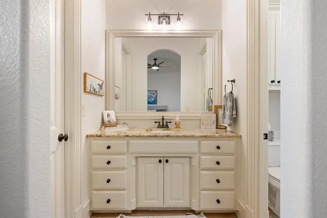 a bathroom with a sink vanity and a mirror
