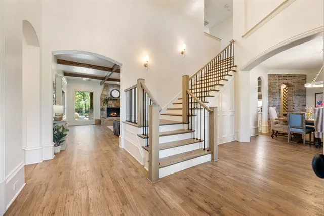 a view of a hallway with wooden floor and furniture