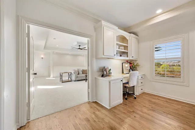 a workspace with kitchen island white cabinets and wooden floor