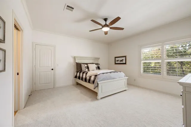 a spacious bedroom with a bed and window
