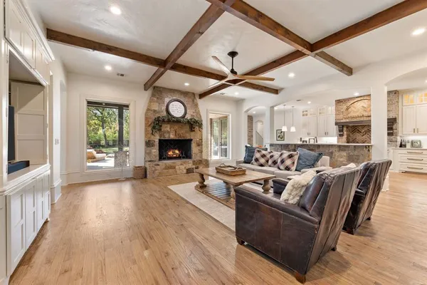 a large white kitchen with cabinets a sink and appliances