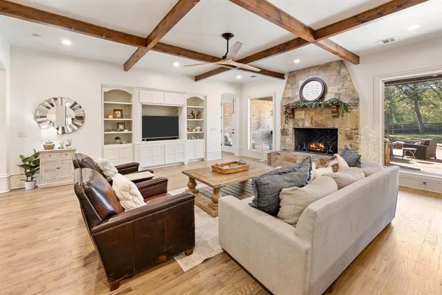 a living room with fireplace furniture and a large window