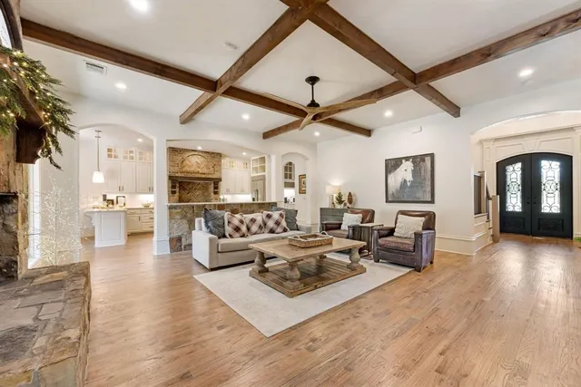 a living room with fireplace furniture and a wooden floor