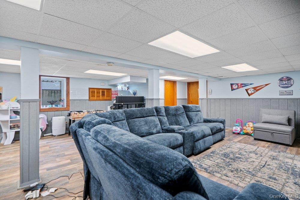 101 Sexton Road West Babylon, NY 11704 - Photo 23 of 33 a living room with furniture and a wooden floor