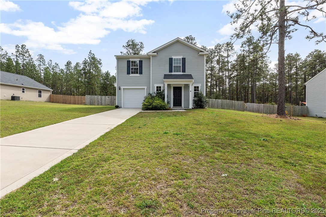 a view of a house with a yard and pathway