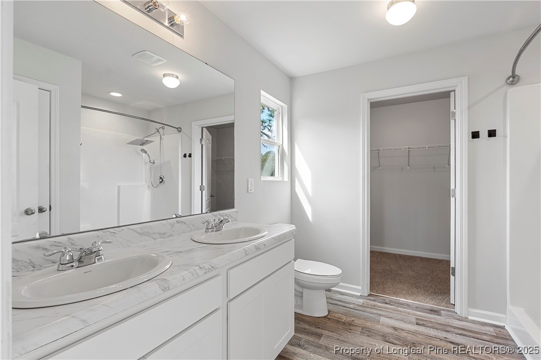 191 Mildred Way Aberdeen, NC 28315 - Photo 14 of 26 a bathroom with a sink a toilet and shower