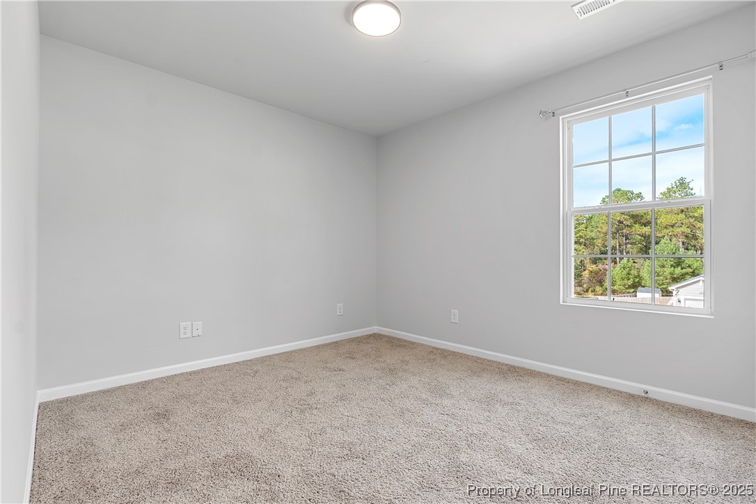 191 Mildred Way Aberdeen, NC 28315 - Photo 16 of 26 an empty room with windows