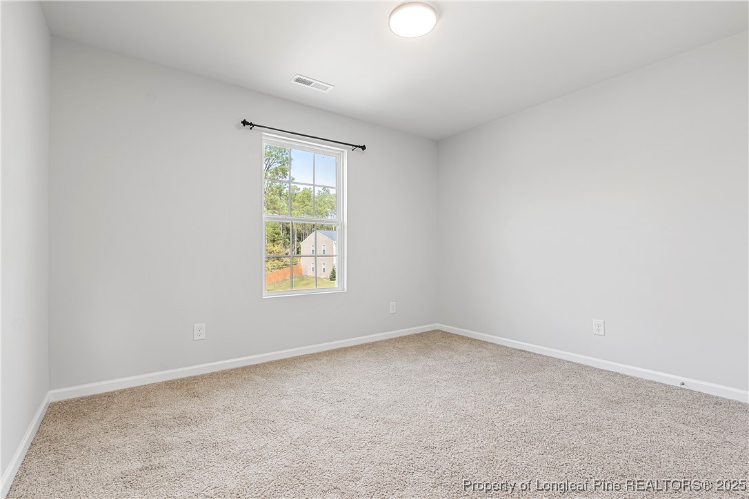 191 Mildred Way Aberdeen, NC 28315 - Photo 18 of 26 an empty room with windows