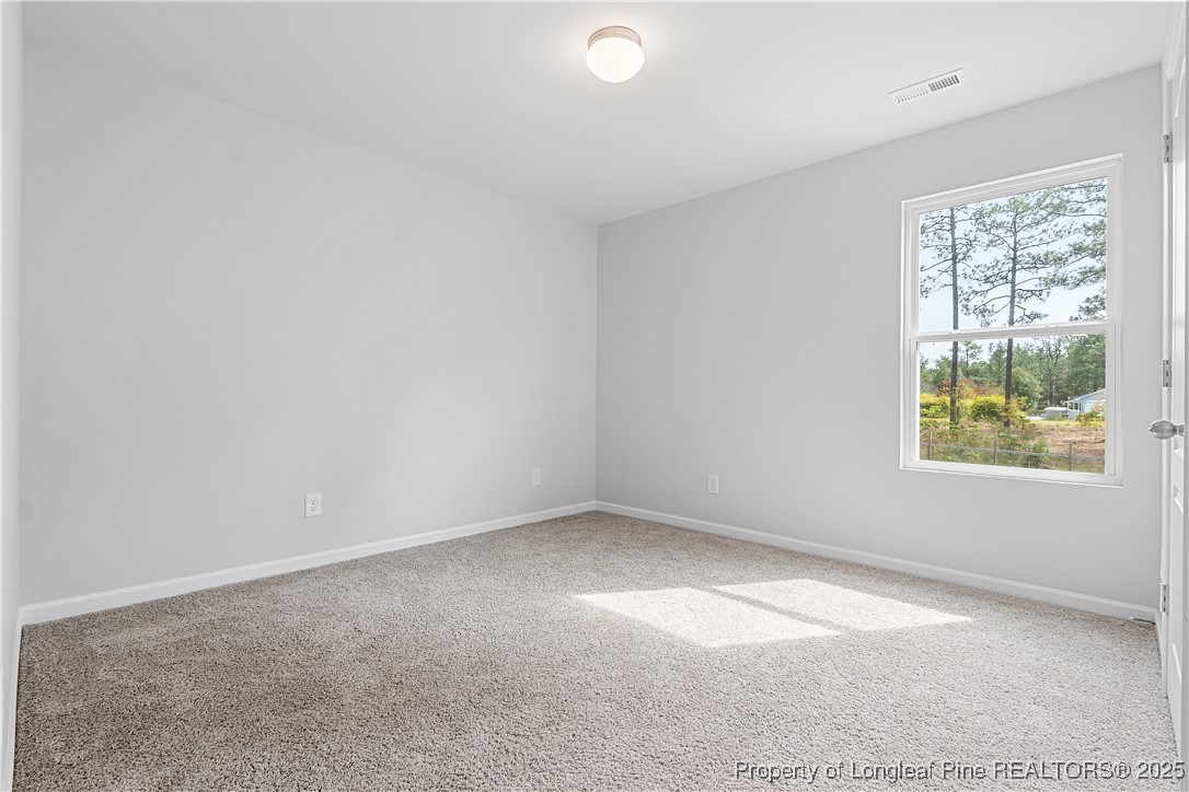 191 Mildred Way Aberdeen, NC 28315 - Photo 22 of 26 an empty room with windows