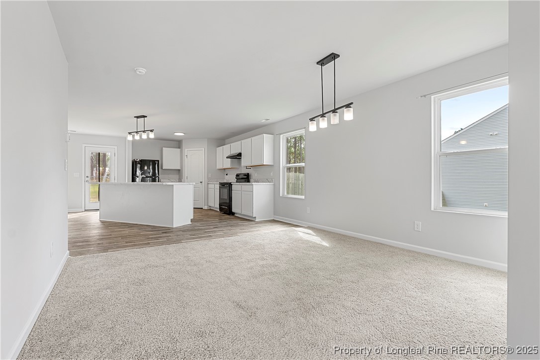 191 Mildred Way Aberdeen, NC 28315 - Photo 4 of 26 a view of a kitchen with a sink and a refrigerator