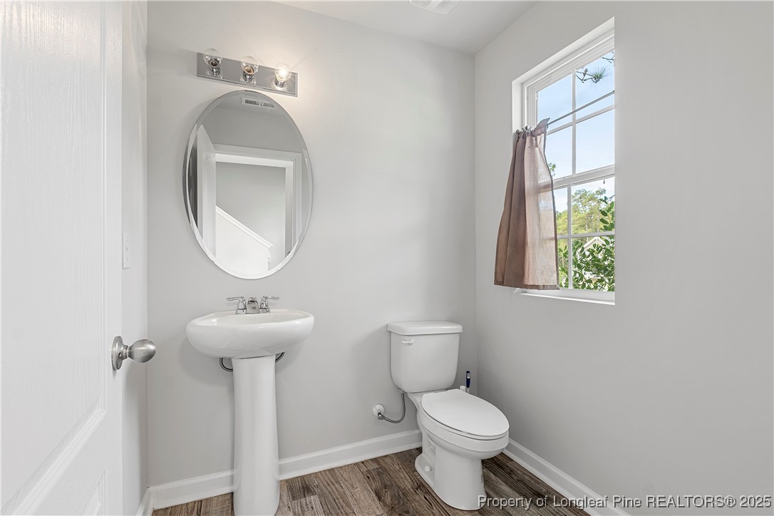 191 Mildred Way Aberdeen, NC 28315 - Photo 6 of 26 a bathroom with a toilet sink and mirror