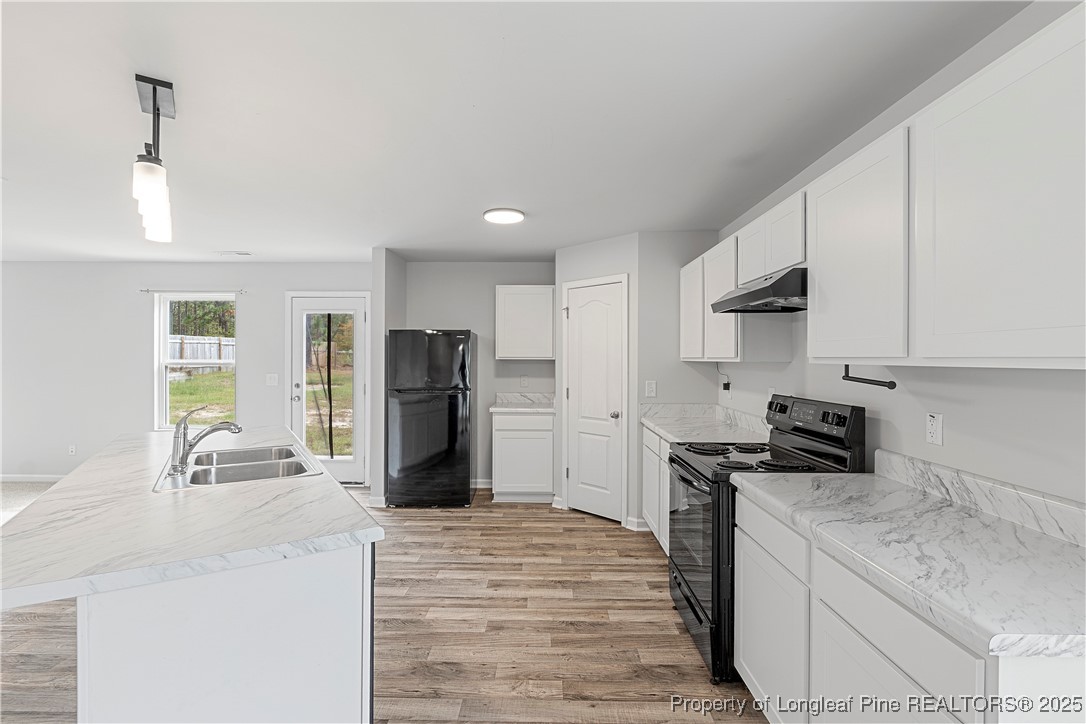 191 Mildred Way Aberdeen, NC 28315 - Photo 7 of 26 a kitchen with stainless steel appliances granite countertop a sink stove and refrigerator