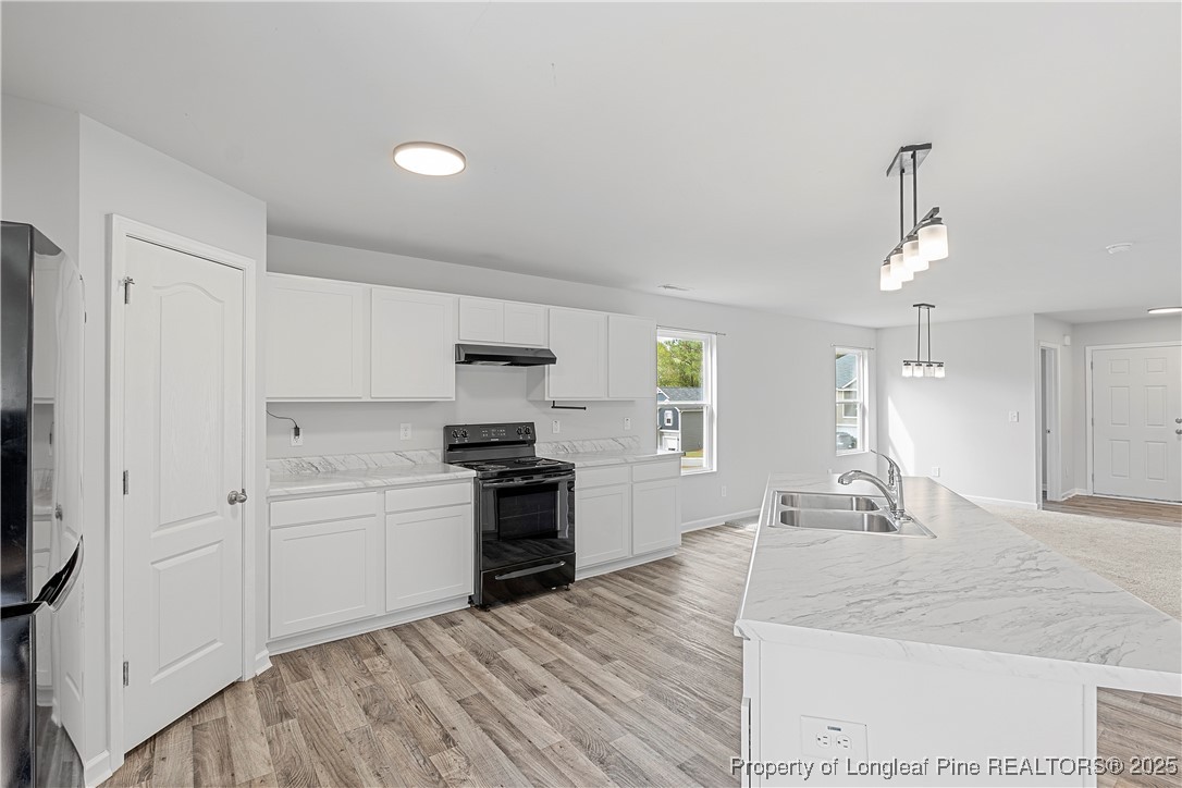 191 Mildred Way Aberdeen, NC 28315 - Photo 9 of 26 a large kitchen with kitchen island a sink stainless steel appliances and cabinets