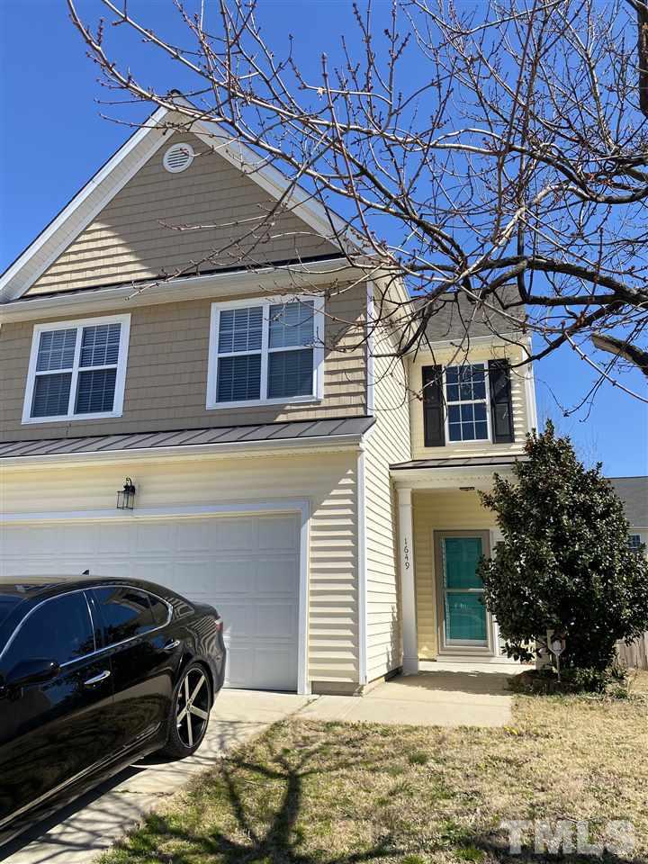 1649 Extine Lane Raleigh, NC 27610 - Photo 2 of 3 a front view of a house with a yard