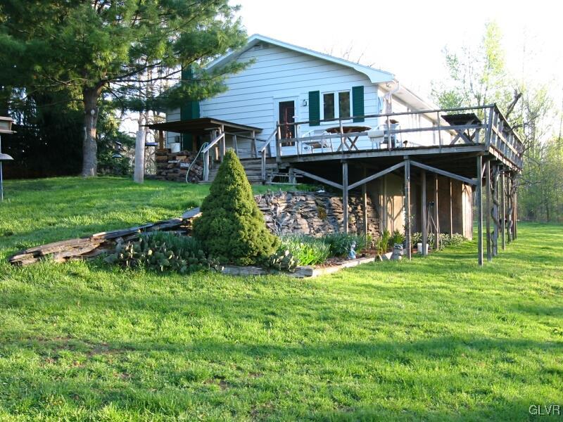 2491 Yost Road Bath, PA 18014 - Photo 38 of 42 a front view of a house with a garden and trees