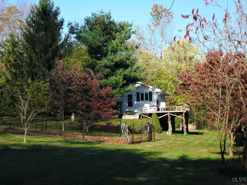 2491 Yost Road Bath, PA 18014 - Photo 7 of 42 a view of a white house in a big yard with large trees