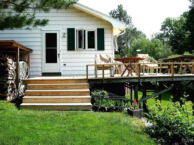 2491 Yost Road Bath, PA 18014 - Photo 9 of 42 a front view of a house with garden and sitting area
