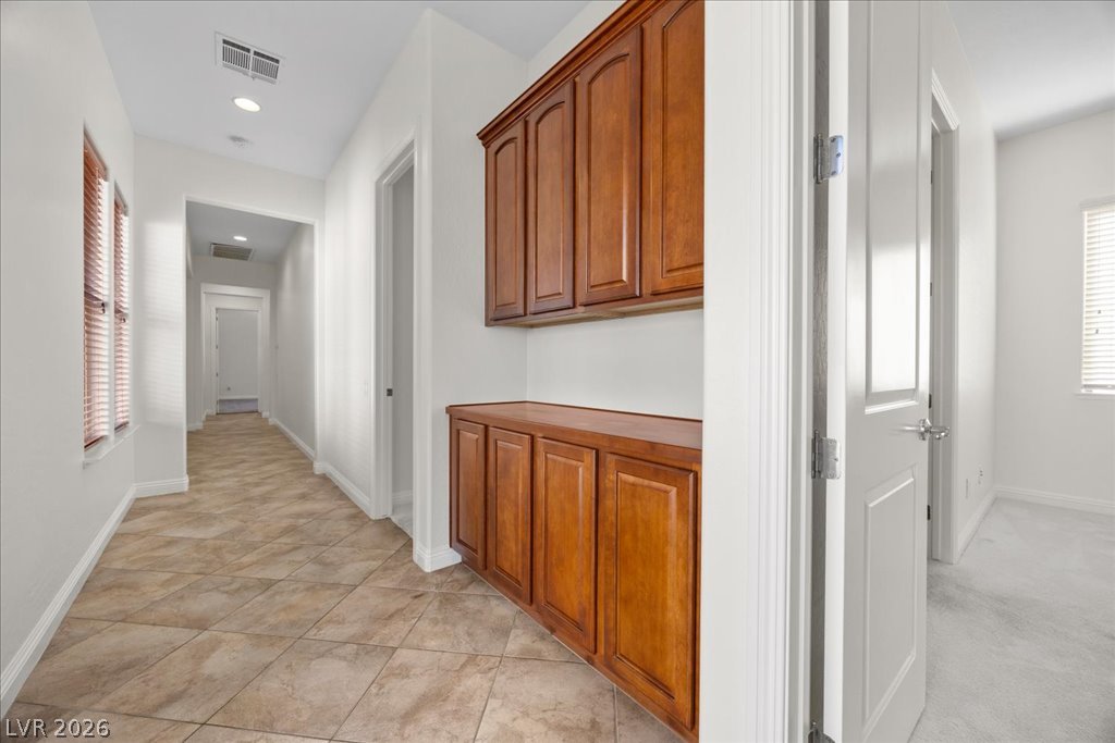 2125 De Rouge Avenue Henderson, NV 89044 - Photo 53 of 96 A well-lit hallway with built-in storage cabinets leads to other areas of the home.