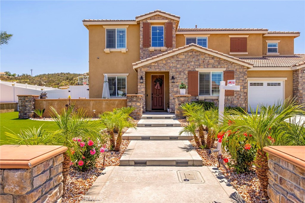 32797 Hayden Road Menifee, CA 92584 - Photo 4 of 51 a front view of a house with a yard and potted plants