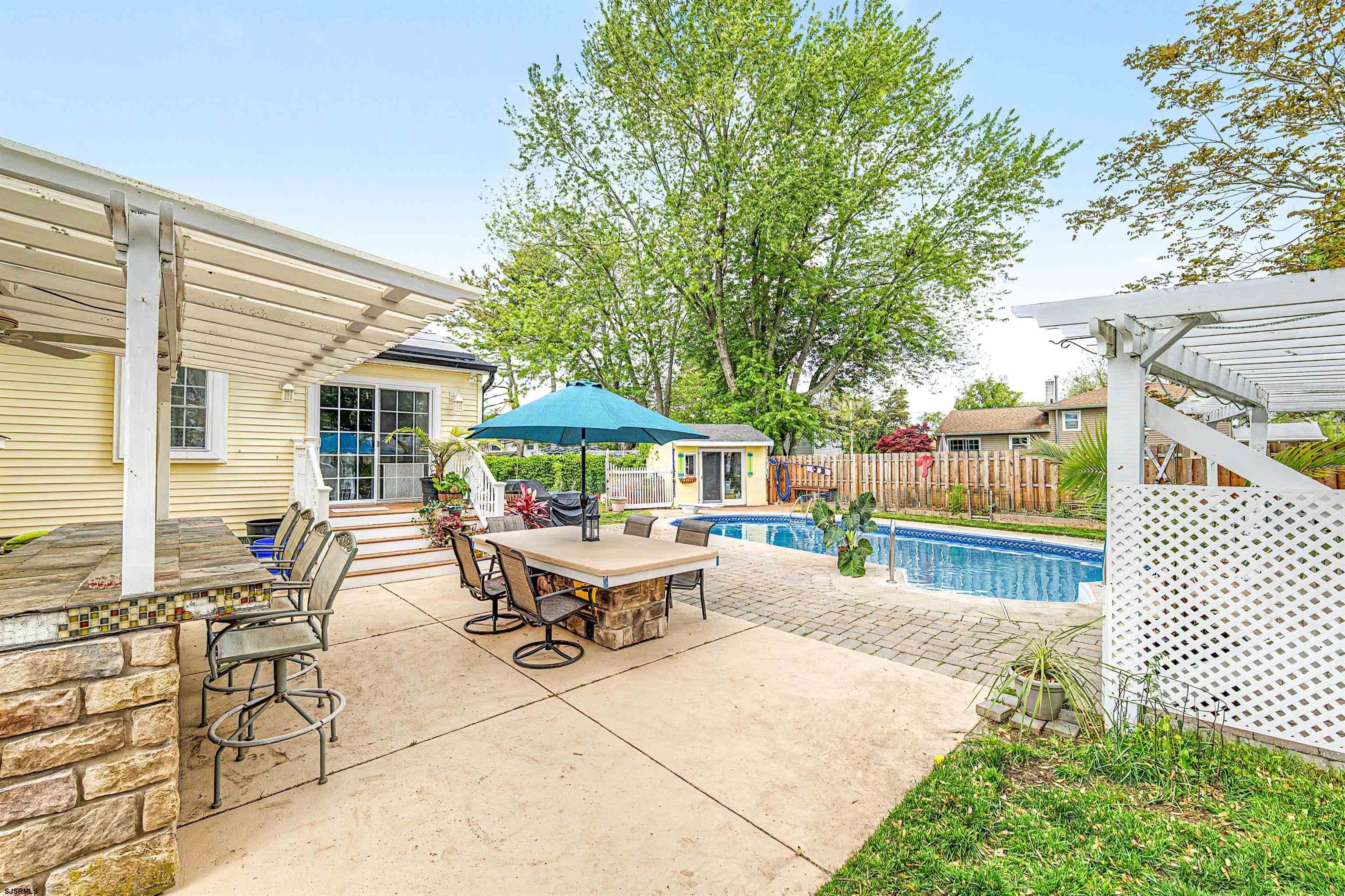 125 Exton Road Somers Point, NJ 08244 - Photo 29 of 35 a patio with a table and chairs under an umbrella