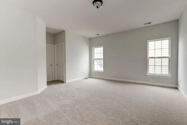 a bathroom with a tub a sink and a large mirror